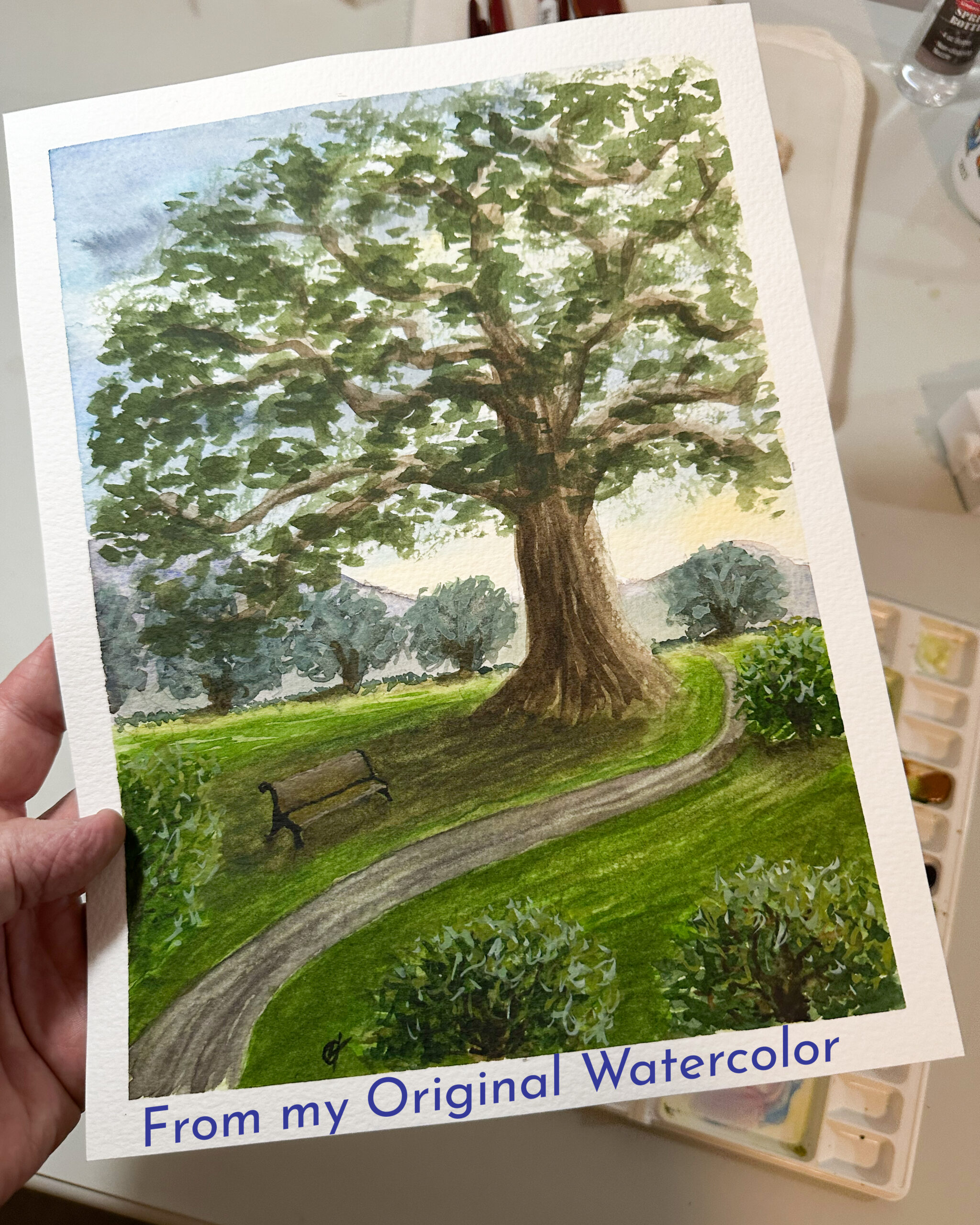 Holding the original watercolor painting Sanctuary