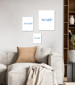 A photo of a living room with a standard sized sofa showing the relative sizes of three pieces of art on a wall; 8x10, 11x14 and 16x20