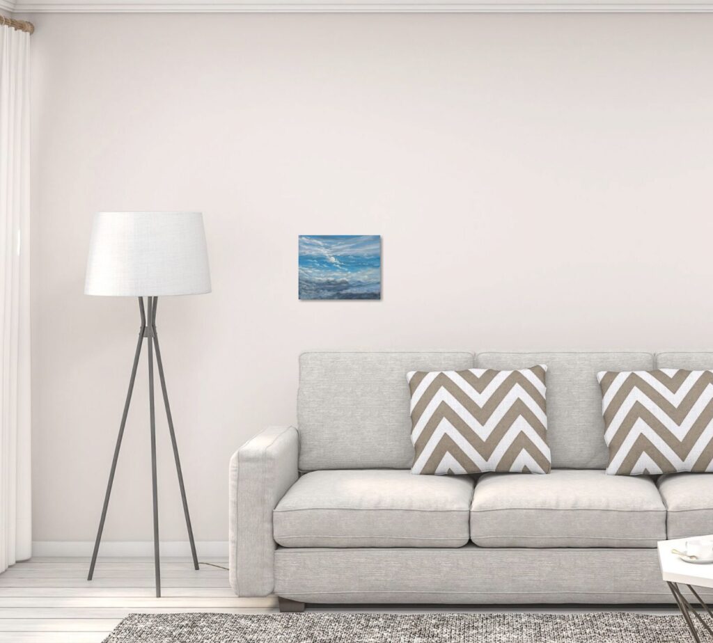 A Piece of art above a sofa that is too small